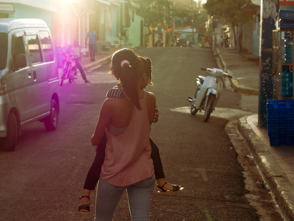 Úprava fotek pomocí křivek: snímek dívky jdoucí po ulici po základních úpravách.